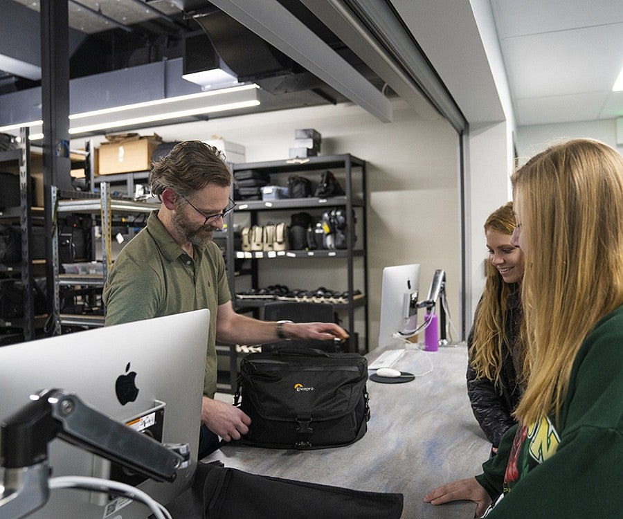 students check out camera equipment from the Allen Hall J-Cage