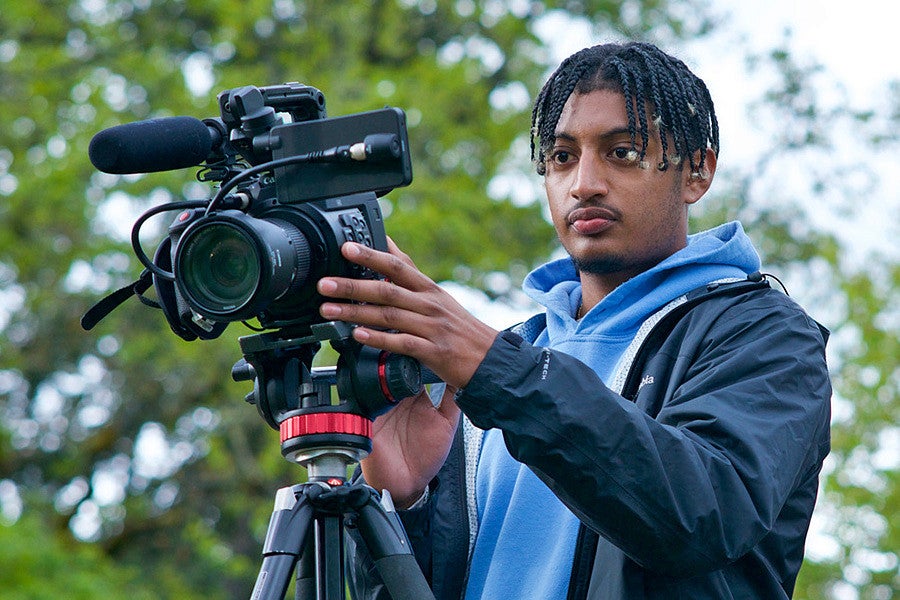 an SOJC student films with a video camera