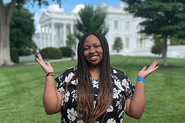 Polly Irungu stands in front of the White House