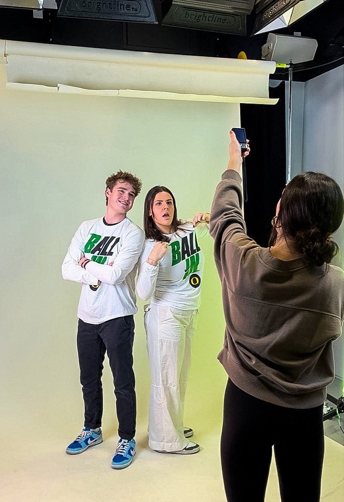 two people wearing the same shirt that says Ball In pose for a studio portrait