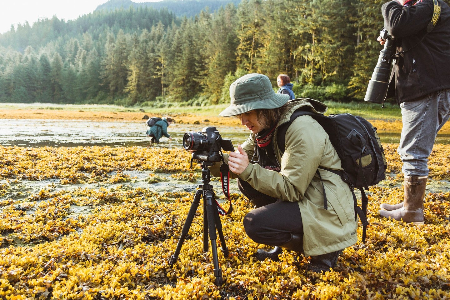 a student shoots photos in a marshy field as part of the SOJC's Science and Memory program