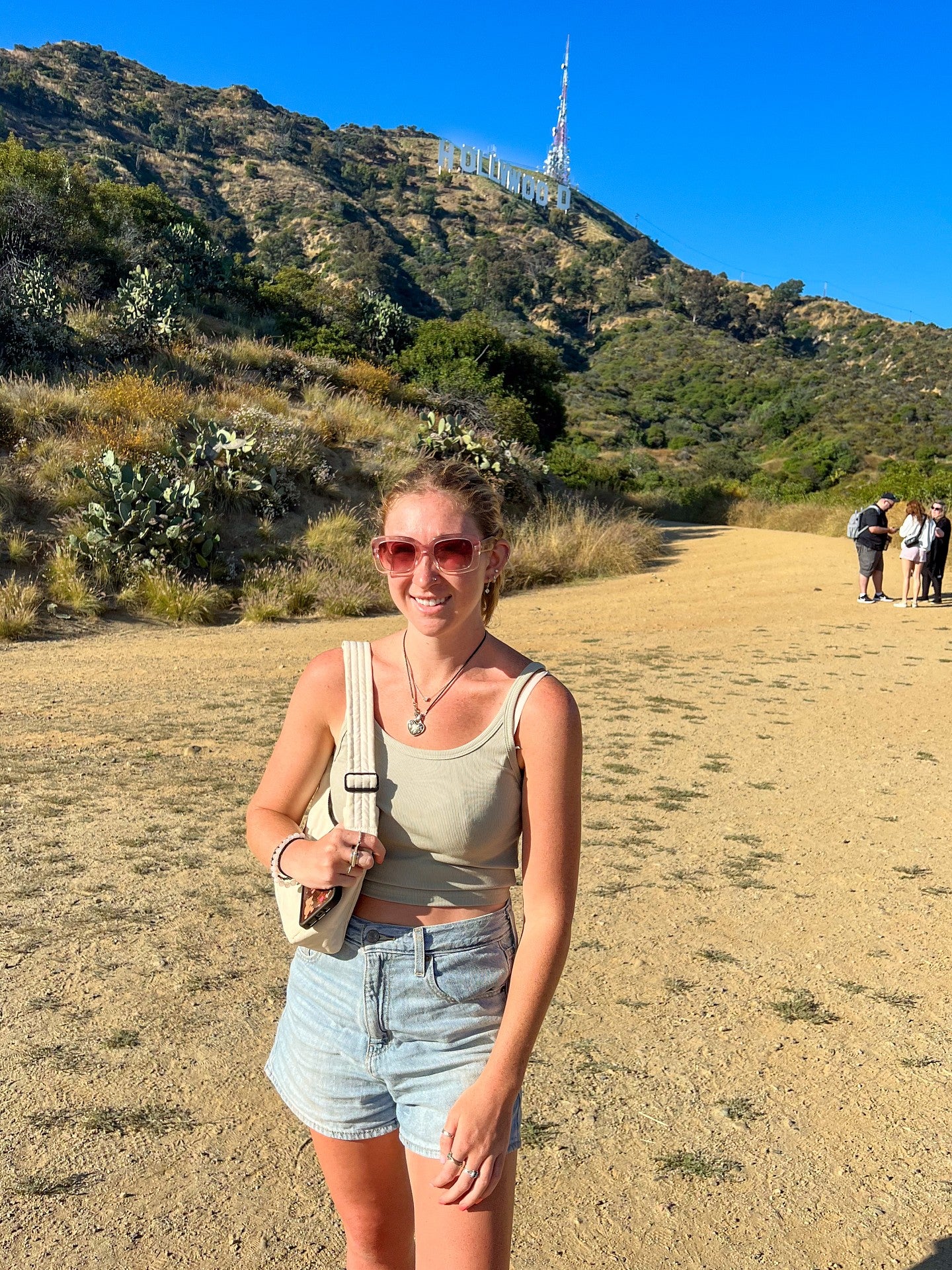 Jane Glazer poses with the Hollywood sign in the background