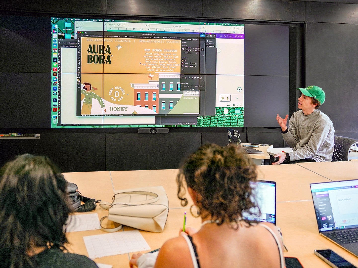 students evaluate a print campaign shown on a large display screen