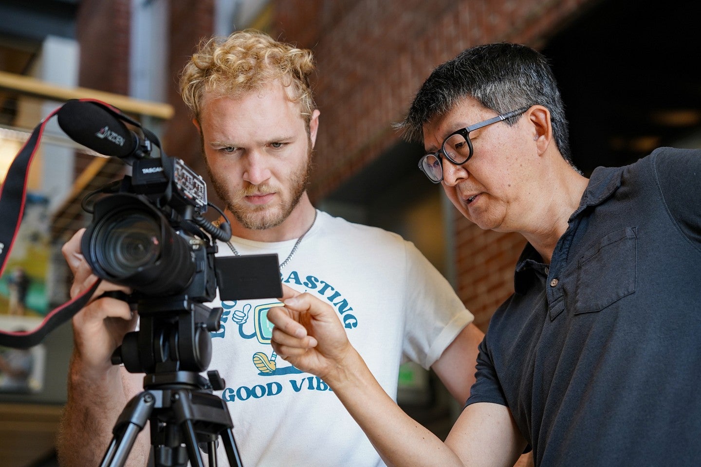 Sung Park instructs a student using a video camera