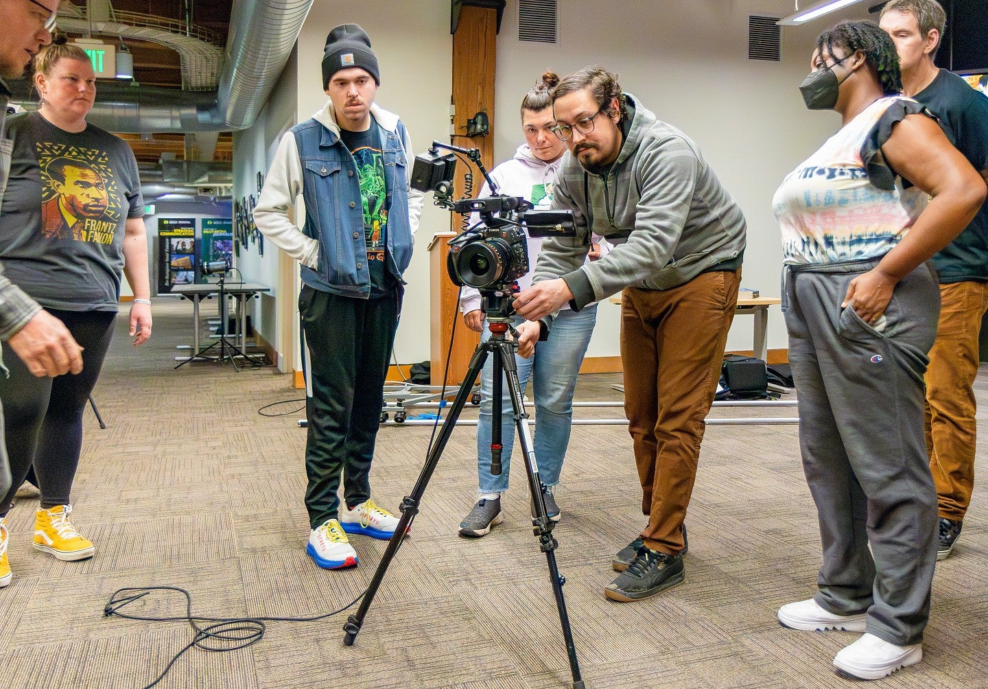 students gather around a video camera