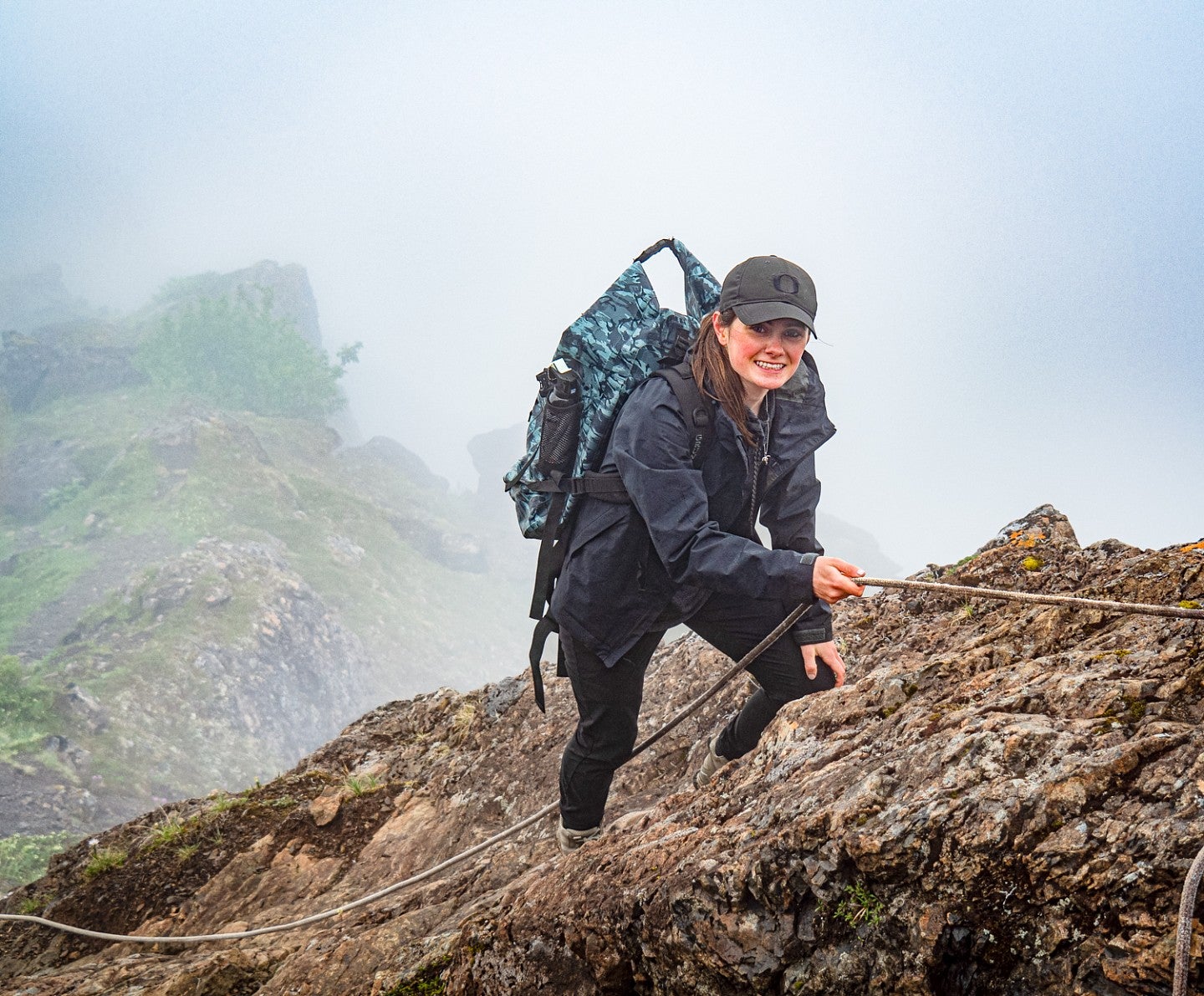 Eden McCall uses a rope to climb up a rocky mountain, guided by her interest in science communication