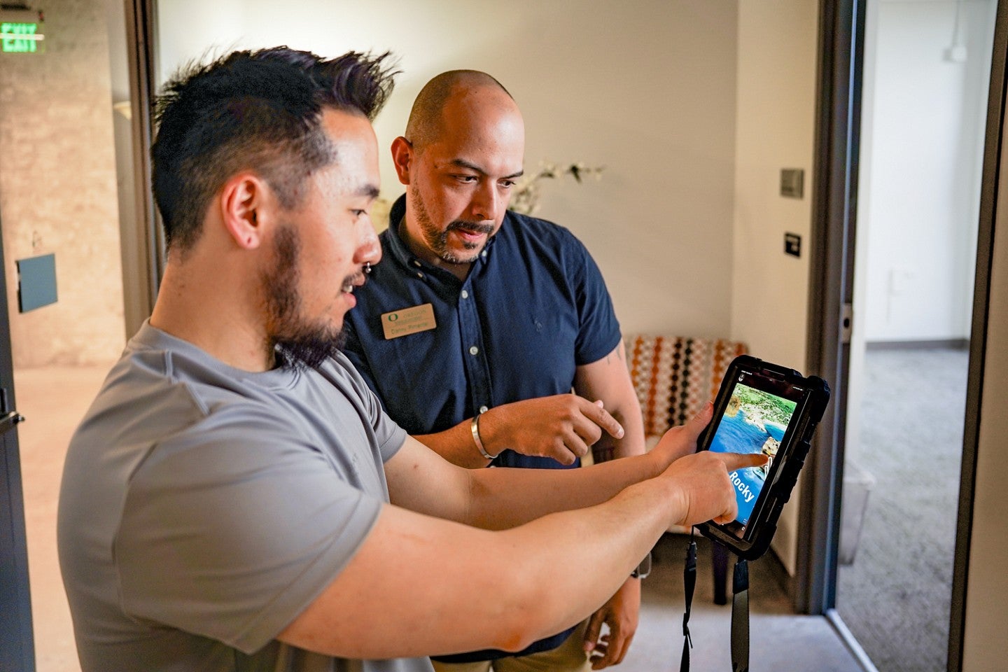 two people explore a virtual reality environment on a small tablet