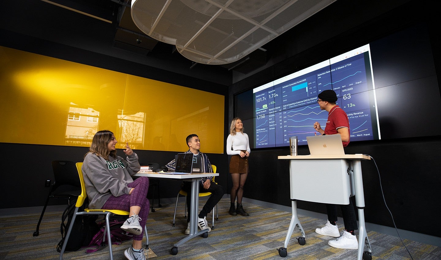 Students working in the Experience Hub Social Media lab inside Allen Hall