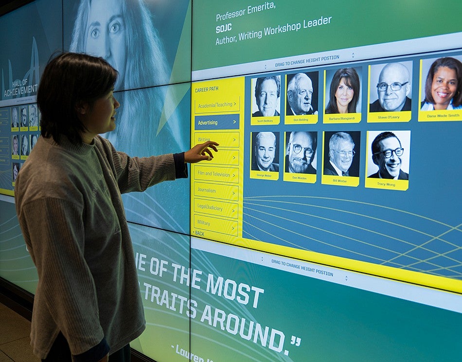 Student explores in the interactive Hall of Achievement touchscreen display. This feature includes information on the Hall of Achievement inductees.