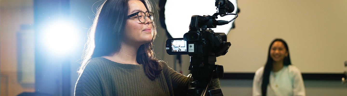 Two students working in the University of Oregon Experience Hub production studio