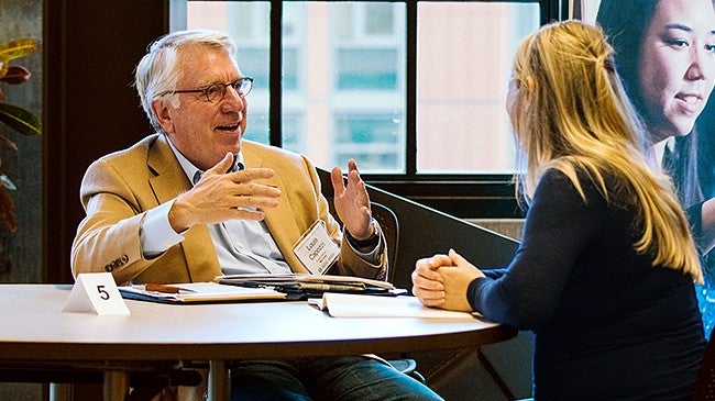 UO alumni speaking with student one-on-one 