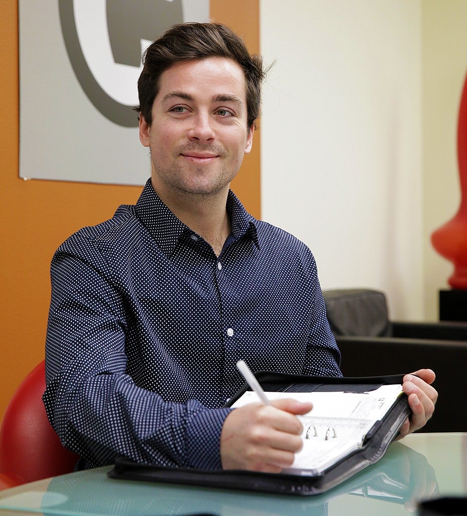 Man taking notes during a student interview. 