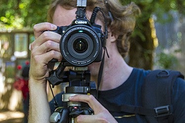 Person taking photograph with Canon camera.