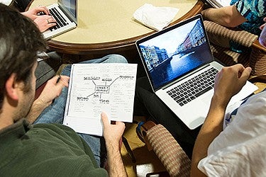 Group of students working together around table.