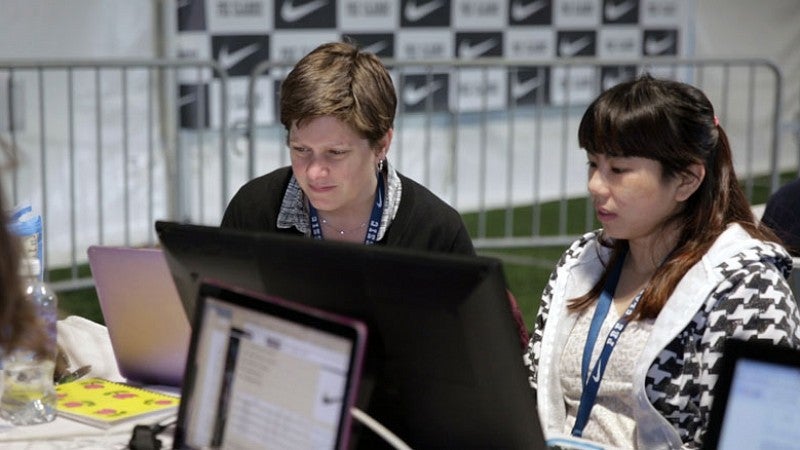 Shontz assists Track Class student Romaine Soh ’17 in the press tent at the 2016 U.S. Olympic Trials.