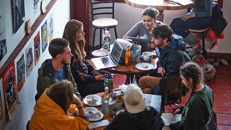 SOJC Science and Memory students meet around small tables in the Whale's Tale cafe in Cordova, Alaska
