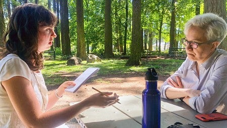 Sierra McClain interviews Oregon Governor Tina Kotek at a picnic table