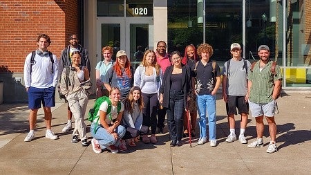 group of students pose outside Allen Hall