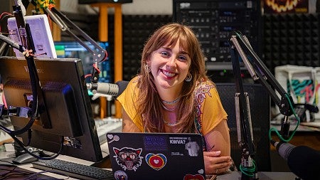 portrait of Kayla Krueger at the DJ desk at KWVA radio