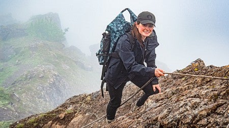 Eden McCall uses a rope to climb up a rocky mountain, guided by her interest in science communication