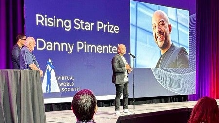 Danny Pimentel stands on a stage to accept the Rising Star Prize at the 2025 Augmented World Expo