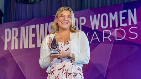 Hannah Oakley poses with her PRNEWS Top Woman in Communications Rising Star award in April 2025