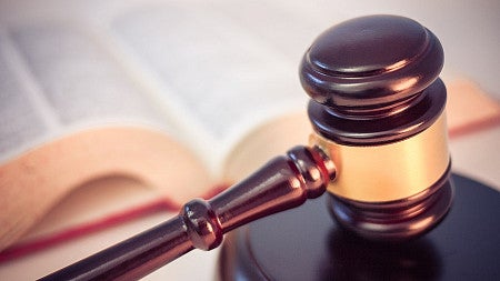 Judge's gavel next to law book.