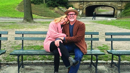 Kari and John Boiler sitting on park bench 