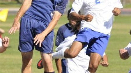 Boy hitting soccer ball with his head