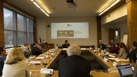 Students sitting around conference room table