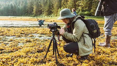 Student Josh Grant sets up camera in field 