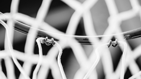 Close uo shot of a basketball hoop in black and white.