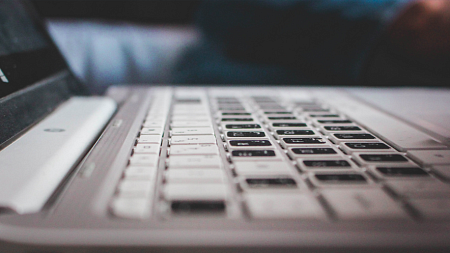 Modern laptop keyboard with black and white keys by Sam Daboul