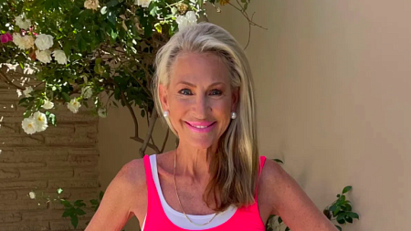 Joanie Bayhack, wearing a bright pink shirt, smile at the camera.