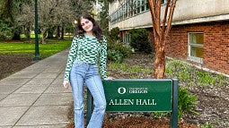 Ella Norton poses with the Allen Hall sign