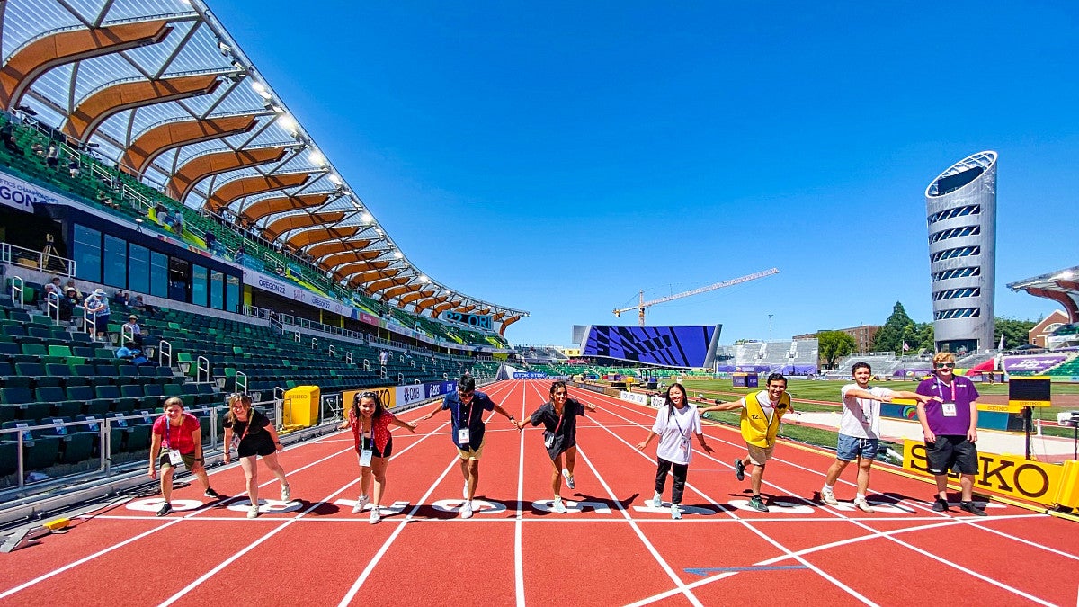 SOJC Track Bureau students pose at the starting line of the track at Hayward Field