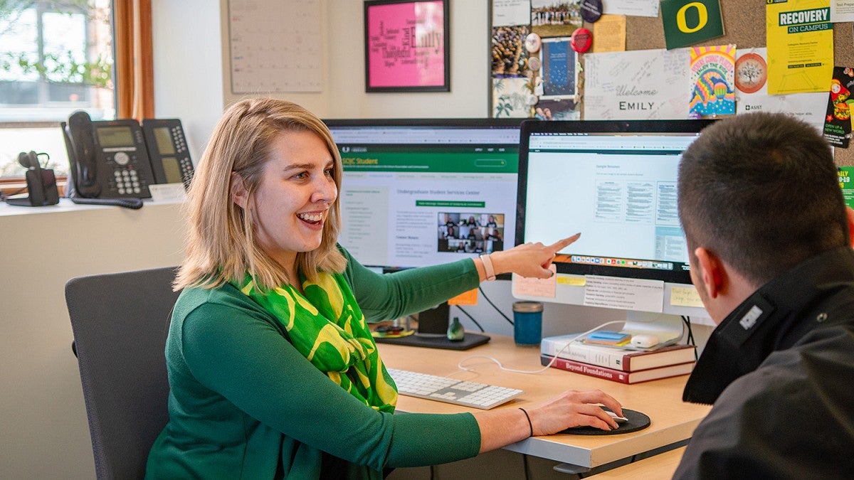 SOJC Student Success Center staff Emily Henkelman advises a student