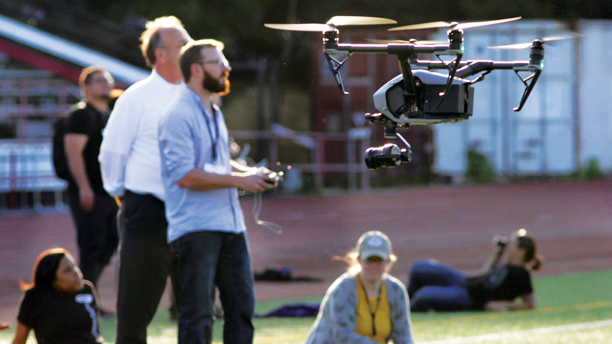 Students learning to fly drone. 