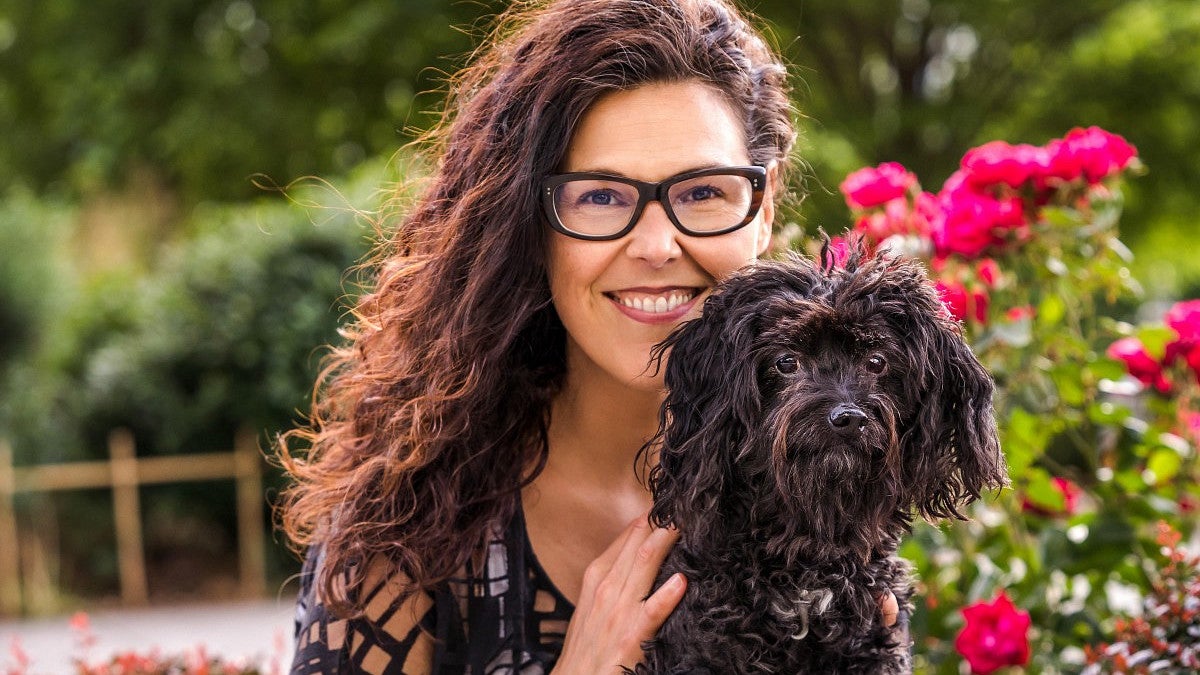 Lisa Peyton and her dog, Betty, pose together for a portrait