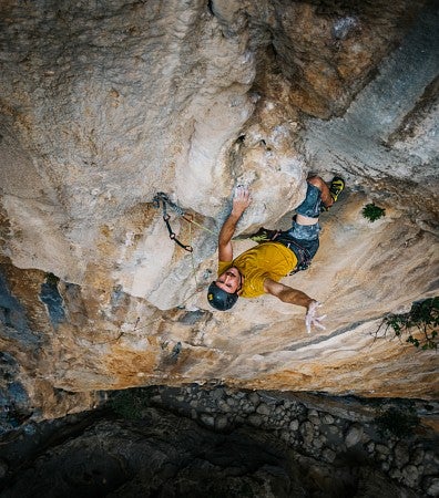 Dan Teitelbaum photo shot from above of a person rock climbing a near-vertical cliff face