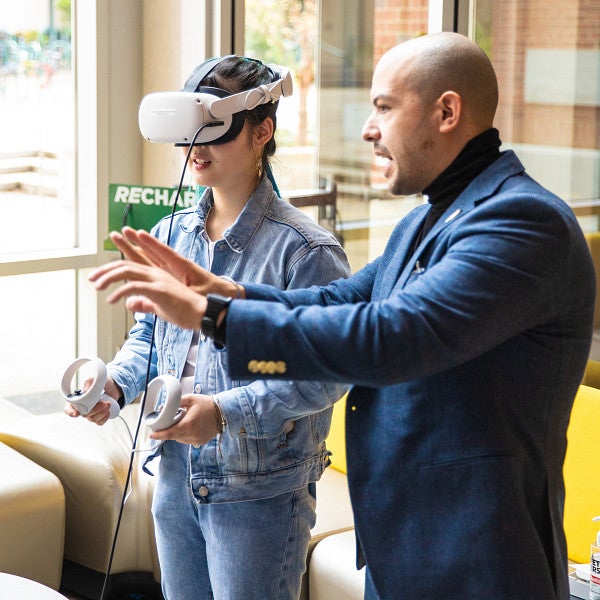 Danny Pimentel instructs a student wearing a VR headset