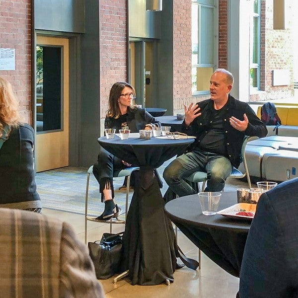 Jane Wildman and Corey duBrowa sit a high-top table in the Allen Hall Atrium