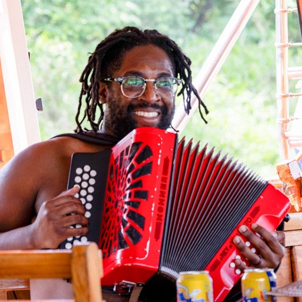 John Adair playing a red accordion