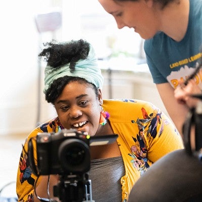 Ranya Salvant operates a video camera while another student looks on