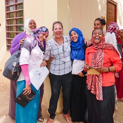 Denise Silfee poses with a group of women in Sudan