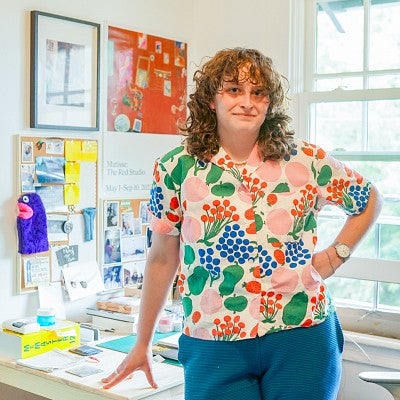 Audrey Kalman wears a vibrant graphic-print top while standing in her studio