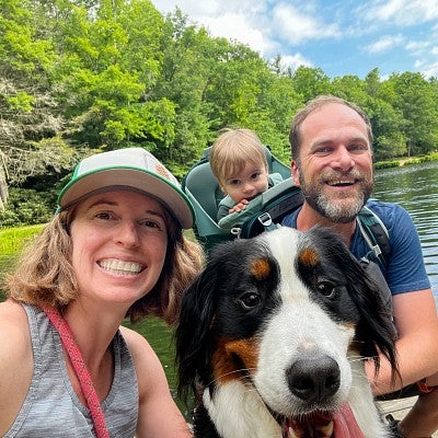 Karen McIntyre poses with her family in front of a river