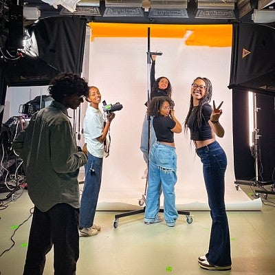 a group of students set up for a portrait session in a photo studio